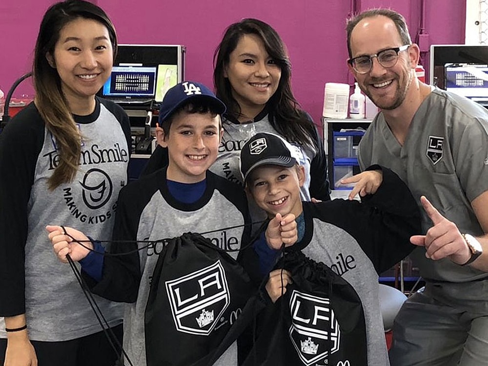 TeamSmile event with children and volunteers smiling.