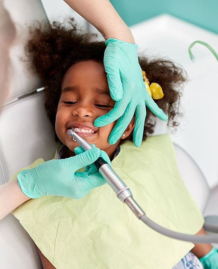 Smiling boy with backpack in outdoor setting.